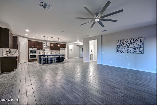 unfurnished living room with ceiling fan