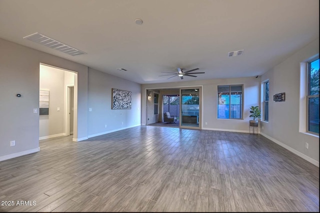 unfurnished living room featuring wood-type flooring and ceiling fan