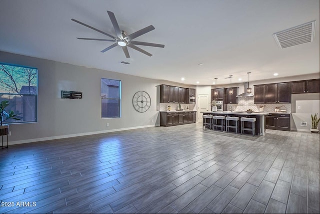 unfurnished living room with sink and ceiling fan