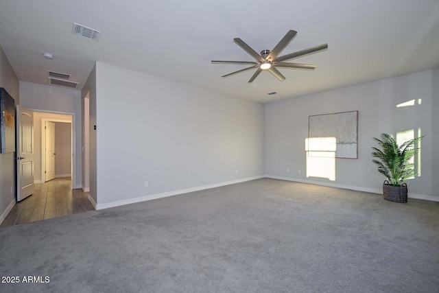 unfurnished room with ceiling fan and dark carpet