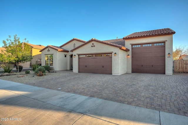 mediterranean / spanish home featuring a garage