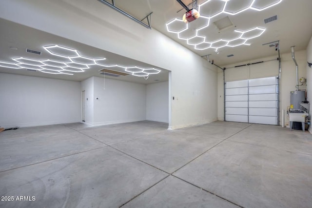 garage featuring a garage door opener and gas water heater