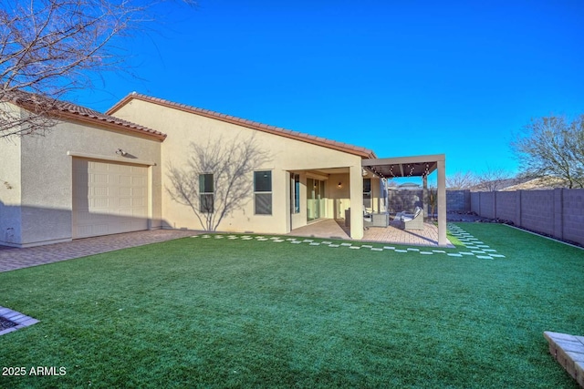 rear view of property with a yard and a patio