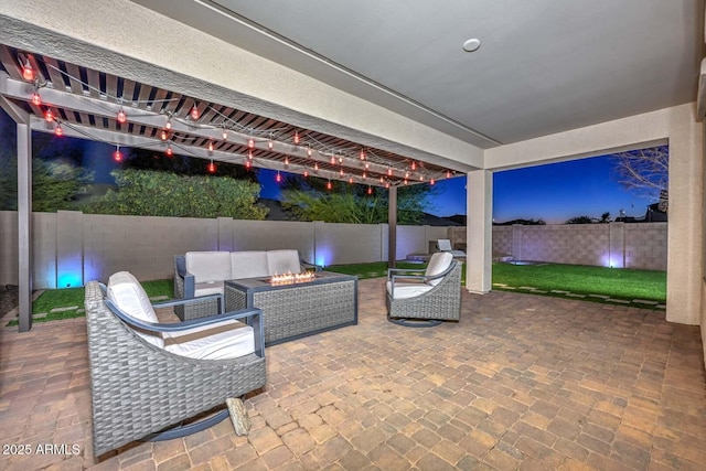 patio terrace at dusk featuring an outdoor living space with a fire pit