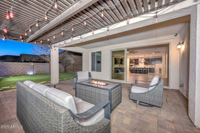 view of patio / terrace featuring an outdoor living space with a fire pit