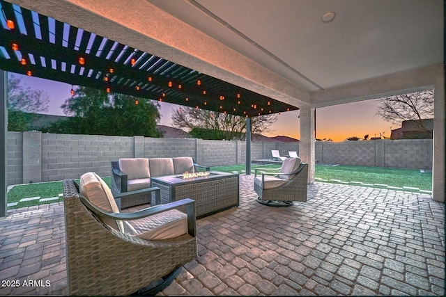 patio terrace at dusk featuring an outdoor living space