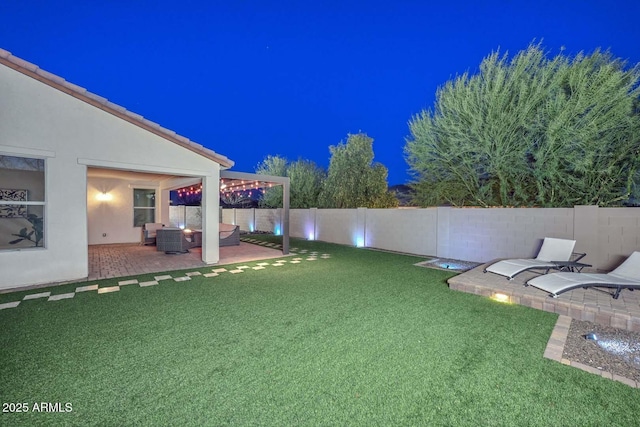 yard at twilight with an outdoor hangout area and a patio area