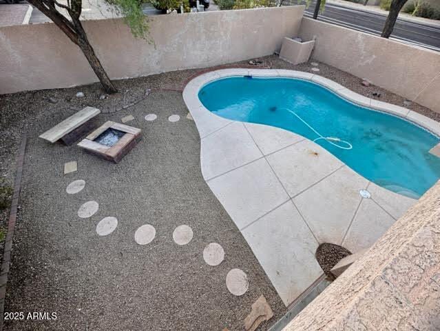 view of swimming pool with a fenced in pool and a patio
