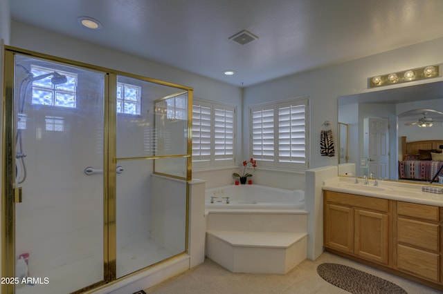 bathroom featuring vanity and shower with separate bathtub