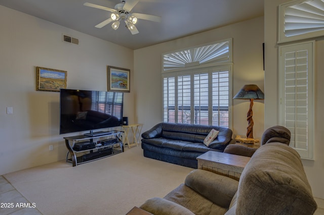 carpeted living room featuring ceiling fan