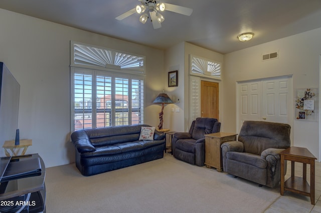 living room featuring ceiling fan and light carpet