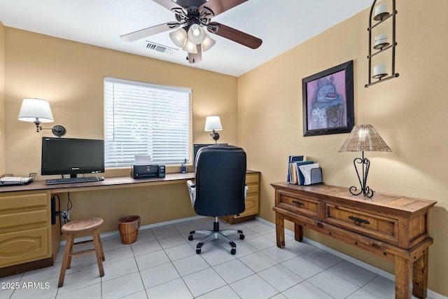 office with light tile patterned floors, baseboards, visible vents, and a ceiling fan