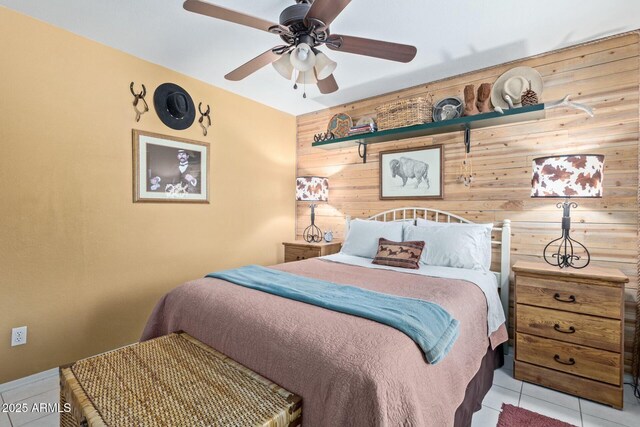 tiled bedroom featuring ceiling fan