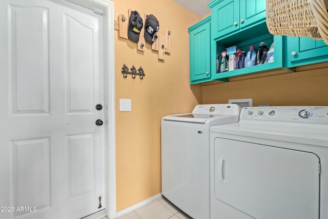 laundry room featuring cabinet space, baseboards, light tile patterned flooring, and independent washer and dryer