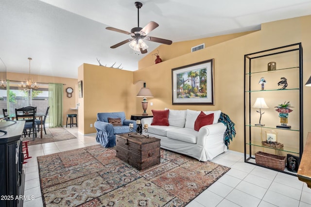 living area with light tile patterned floors, ceiling fan with notable chandelier, lofted ceiling, and visible vents