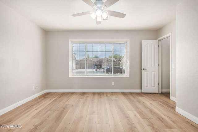 empty room featuring ceiling fan and light hardwood / wood-style flooring