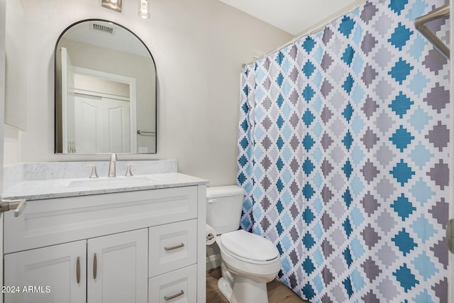 bathroom featuring hardwood / wood-style floors, vanity, and toilet