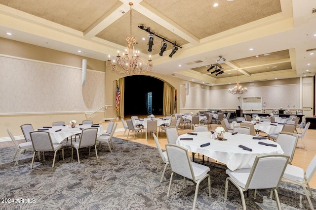 dining space with beamed ceiling, coffered ceiling, and an inviting chandelier