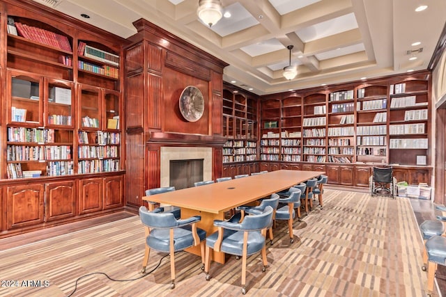 office space with a fireplace, built in features, coffered ceiling, and beam ceiling