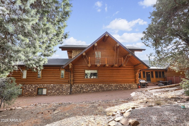 back of house featuring a patio, a balcony, and a sunroom