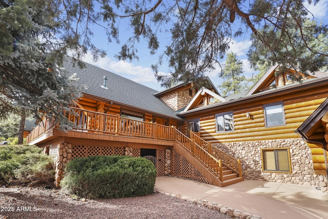 rear view of house featuring a patio and a deck