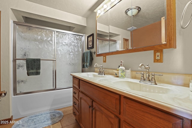 bathroom featuring vanity, tile patterned floors, a textured ceiling, and shower / bath combination with glass door