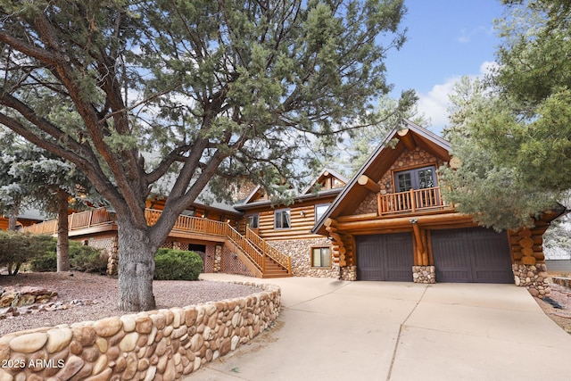 log home with a garage and a deck