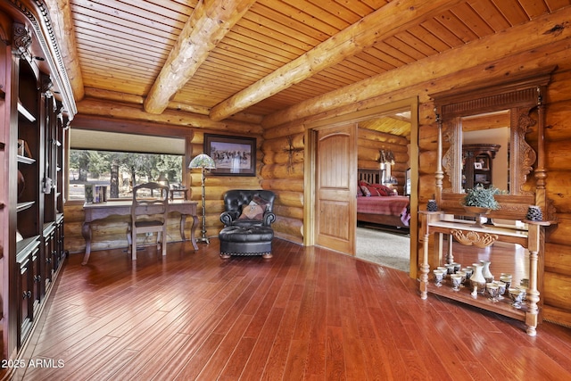 sitting room featuring wood ceiling, wood-type flooring, and beamed ceiling