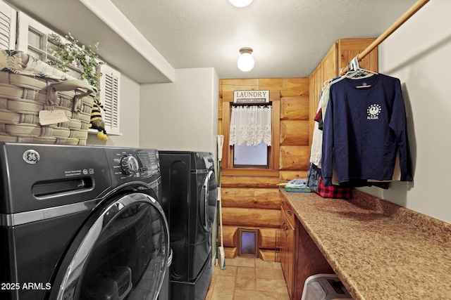 washroom with washer and dryer and rustic walls