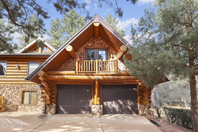 log home with a garage and a balcony