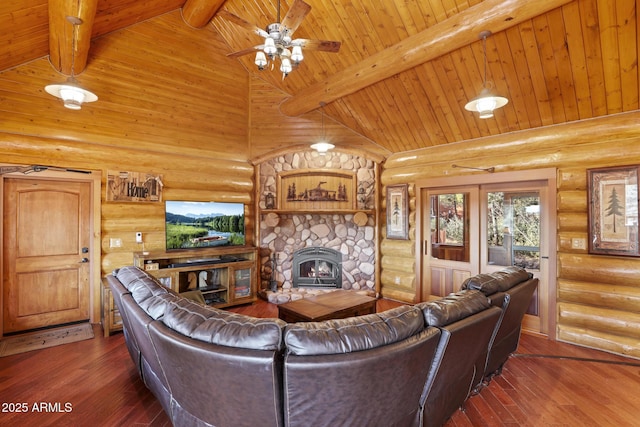 living room featuring beam ceiling, a stone fireplace, dark hardwood / wood-style floors, and high vaulted ceiling