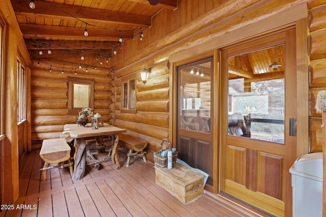 sunroom / solarium featuring beam ceiling and wood ceiling