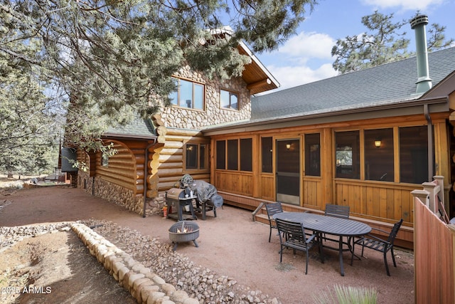 back of house featuring a patio area and a fire pit