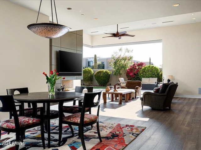 dining area with hardwood / wood-style floors and ceiling fan