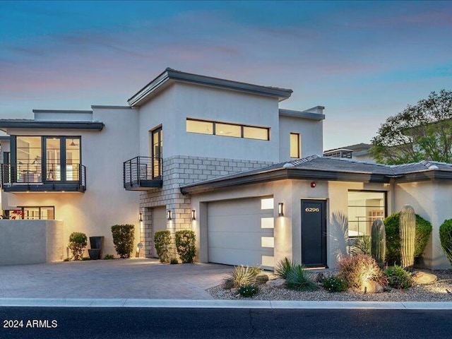 view of front of house featuring a balcony and a garage