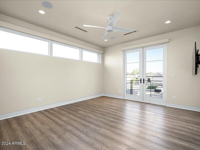 spare room featuring dark hardwood / wood-style floors, french doors, and ceiling fan