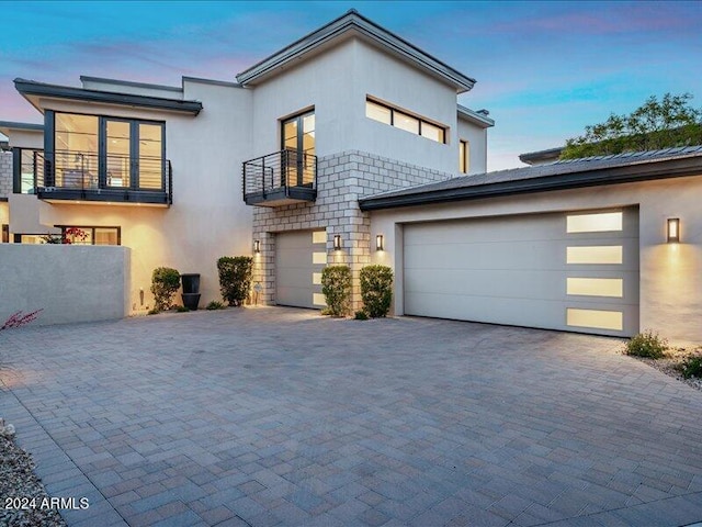 modern home featuring a garage and a balcony