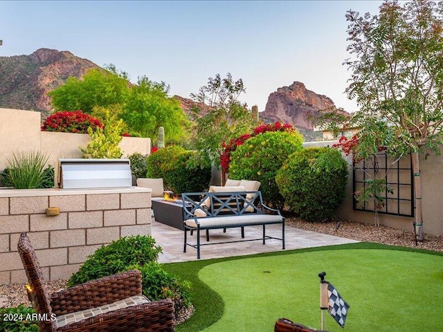 view of yard with a patio area, an outdoor living space, and a mountain view