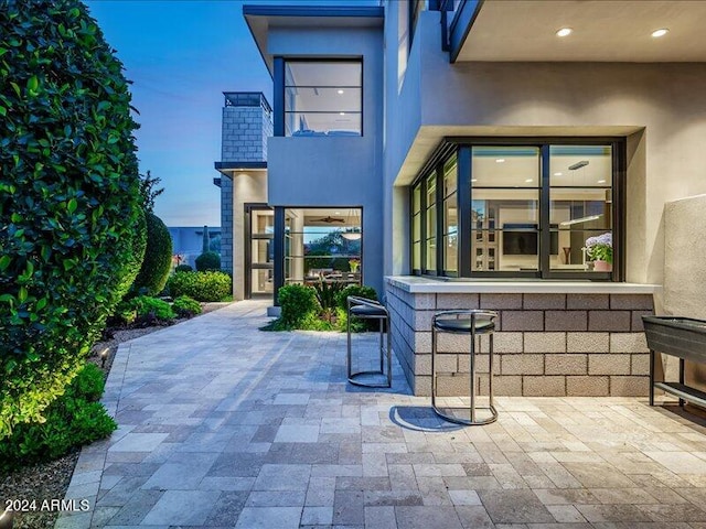 view of patio terrace at dusk