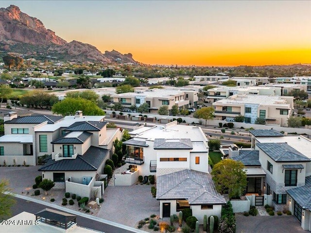 aerial view at dusk featuring a mountain view