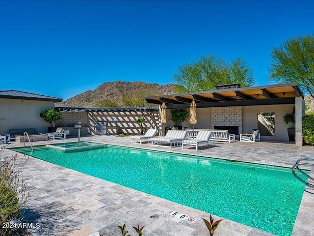 view of swimming pool with a patio, a mountain view, and a pergola