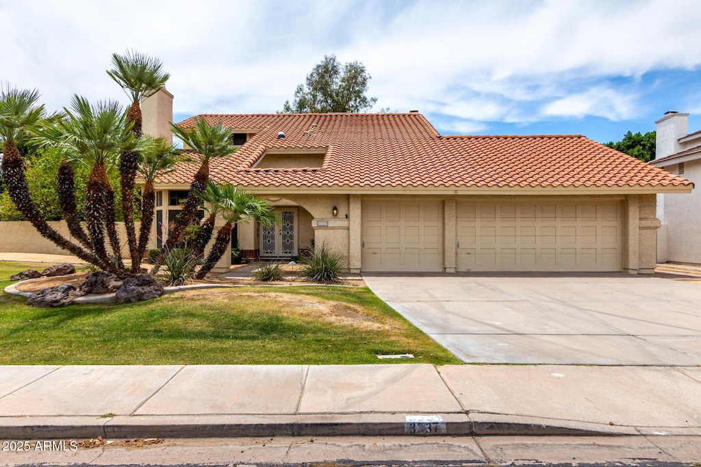 3337 E Glade Cir, Mesa, AZ 85204 - mediterranean / spanish-style house featuring a garage, driveway, a tiled roof, french doors, and stucco siding