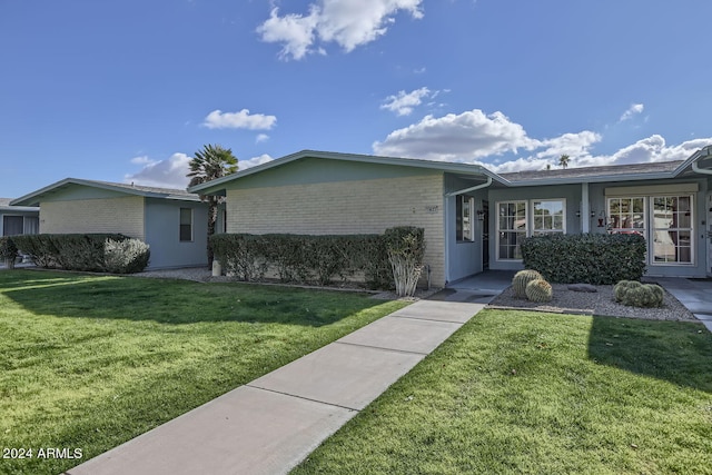 ranch-style home featuring a front yard