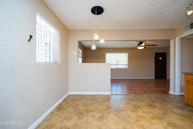 1301 N Santa Rosa Ave, Tucson, AZ 85712 - spare room with light tile patterned floors, visible vents, baseboards, and a ceiling fan