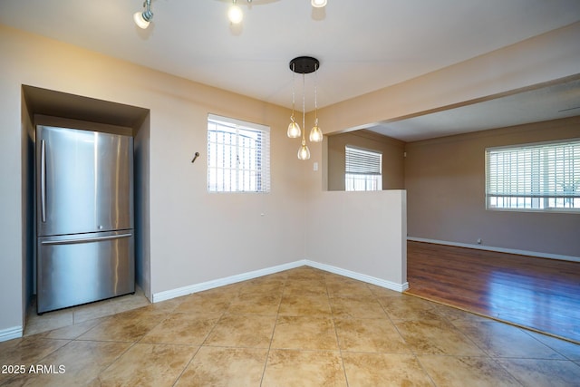 1301 N Santa Rosa Ave, Tucson, AZ 85712 - unfurnished dining area with light tile patterned floors and baseboards