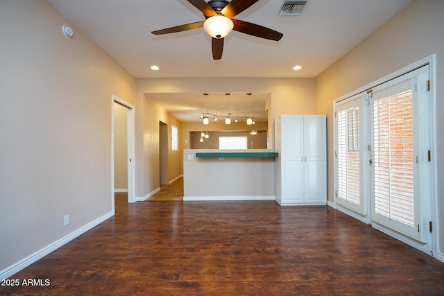1301 N Santa Rosa Ave, Tucson, AZ 85712 - unfurnished living room featuring visible vents, baseboards, ceiling fan, recessed lighting, and wood finished floors