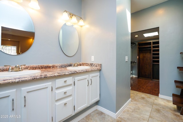 1301 N Santa Rosa Ave, Tucson, AZ 85712 - full bath featuring a spacious closet, tile patterned flooring, double vanity, and a sink