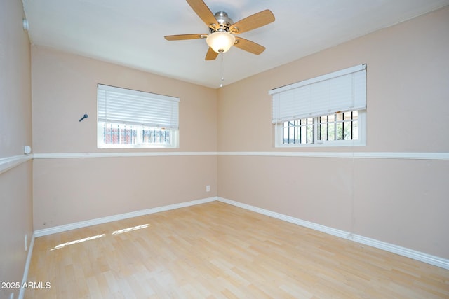 1301 N Santa Rosa Ave, Tucson, AZ 85712 - unfurnished room with wood finished floors, ceiling fan, and baseboards