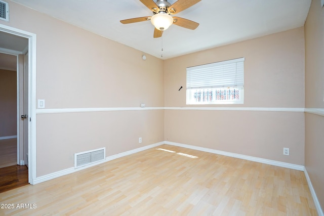 1301 N Santa Rosa Ave, Tucson, AZ 85712 - spare room with visible vents, baseboards, a ceiling fan, and wood finished floors