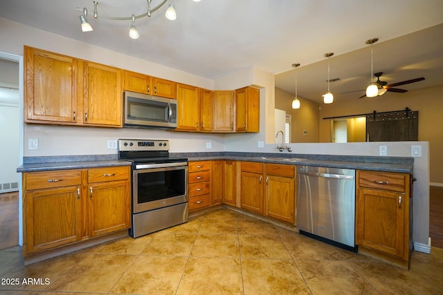 1301 N Santa Rosa Ave, Tucson, AZ 85712 - kitchen featuring stainless steel appliances, brown cabinetry, and a sink